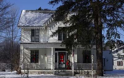 Large white house decorated for Christmas